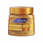 La’Fresh Gold scrub jar with golden exfoliating texture, featuring deep exfoliating face and body scrub formula enriched with gold, collagen, and vitamin E in a 500ml container.