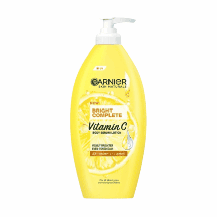 Yellow Garnier Skin Naturals Bright Complete Vitamin C body serum lotion bottle with a white pump, featuring lemon and vitamin C graphics on the label against a white background.
