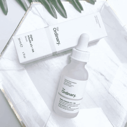 The Ordinary Alpha Arbutin 2% + HA serum with box flat lay on white surface