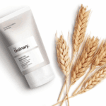 The Ordinary Azelaic Acid Suspension 10% tube displayed beside wheat stalks