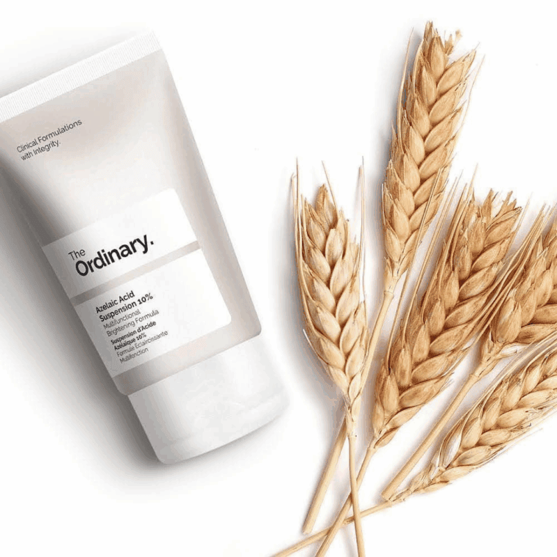 The Ordinary Azelaic Acid Suspension 10% tube displayed beside wheat stalks