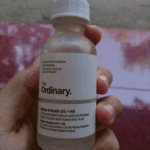 The Ordinary Alpha Arbutin 2% + HA serum bottle held in hand