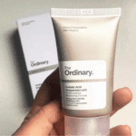 Hand holding The Ordinary Azelaic Acid Suspension 10% skincare tube