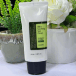 COSRX Aloe Soothing Sun Cream SPF 50+ PA+++ 50ml standing upright with green plants background