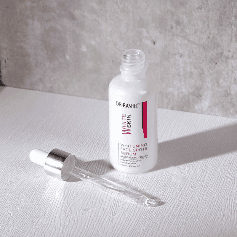 Open Dr. Rashel Whitening Fade Spots Serum bottle with glass dropper placed beside it, highlighting liquid serum texture.
