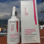 Dr. Rashel White Skin Whitening Fade Spots Serum bottle displayed with outer box, featuring arbutin and niacinamide for dark spot reduction.