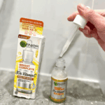 Garnier Bright Complete 30x Vitamin C Booster Serum bottle with dropper being used to dispense serum