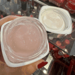 Open L’Oréal Glycolic-Bright Night Cream showing pink gel texture inside the jar