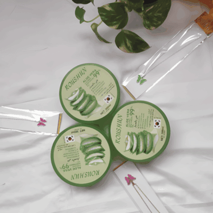 Flat lay view of Roushun Aloe Vera 99% soothing moisturizing gel tubs arranged on a white background with green leaves.