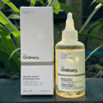 The Ordinary Glycolic Acid 7% Exfoliating Toner bottle and box photographed outdoors with green plants