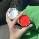 Open Vaseline Rosy Lips Lip Therapy tin displaying smooth pink balm texture in natural light