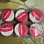 Multiple Vaseline Rosy Lips Lip Therapy tins packed together in transparent plastic wrap