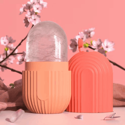 Pink silicone ice roller with capsule-shaped cover used for facial cooling and skincare, displayed with soft floral background