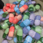 Bulk collection of silicone ice rollers in assorted colors including pink, green, blue, and purple, wrapped and ready for sale