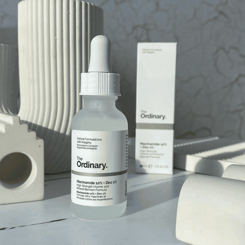 The Ordinary Niacinamide 10% + Zinc 1% serum bottle styled with neutral decor and packaging