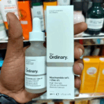The Ordinary Niacinamide 10% + Zinc 1% serum bottle next to its box on a store shelf