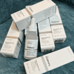 Multiple boxes and one bottle of The Ordinary Niacinamide 10% + Zinc 1% serum arranged together