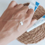 Small amount of CeraVe Eye Repair Cream applied on hand showing creamy texture