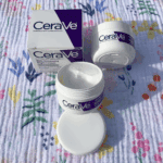 Open CeraVe Skin Renewing Night Cream jar showing cream texture with box beside it