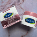 Cetaphil Healthy Radiance Brightening Cream packaging and cream jar placed on marble surface