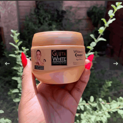 Hand holding Gluta White whitening cream jar with glutathione and collagen in natural outdoor lighting
