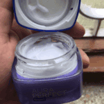 Open jar of L’Oréal Paris Aura Perfect Night Cream showing smooth white cream texture inside the purple container