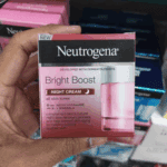 Neutrogena Bright Boost Night Cream box held in hand showing product details, Neoglucosamine minerals, and night use label