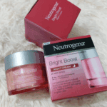 Neutrogena Bright Boost Night Cream jar displayed next to box packaging on white background showing night cream skincare product