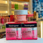 Neutrogena Bright Boost Night Cream jars and boxes displayed on store counter with pink packaging and night cream branding