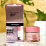 Neutrogena Bright Boost gel cream jar displayed beside its pink and black retail box