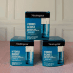 Three Neutrogena Hydro Boost Water Gel jars placed on top of product boxes in retail setting