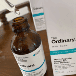 Close-up of The Ordinary Multi-Peptide Serum for Hair Density bottle with dropper and packaging