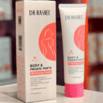 Dr. Rashel body and private parts whitening cream tube displayed beside its box on store shelf background