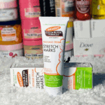 Palmer’s Cocoa Butter Stretch Marks Massage Cream displayed with box packaging on textured surface in retail setting