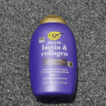 OGX Biotin and Collagen Volumising Shampoo bottle photographed on a grey textured surface