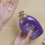 OGX Biotin and Collagen Shampoo being dispensed onto a palm showing creamy shampoo texture