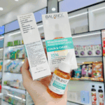 Balance Active Formula Niacinamide Blemish Recovery Serum packaging held in hand inside store