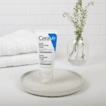 CeraVe Facial Moisturising Lotion displayed on a tray with towel and plant background