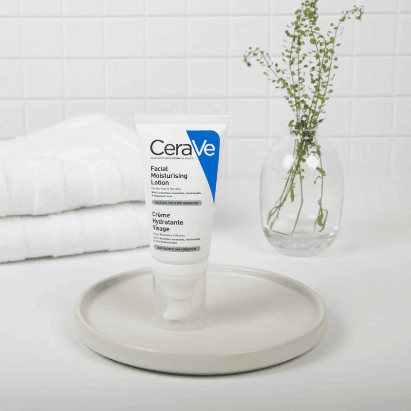 CeraVe Facial Moisturising Lotion displayed on a tray with towel and plant background
