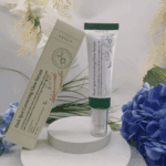 AXIS-Y Dark Spot Correcting Glow Serum 50ml displayed with original packaging and floral background