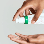 AXIS-Y Dark Spot Correcting Glow Serum being dispensed onto hand showing lightweight serum texture
