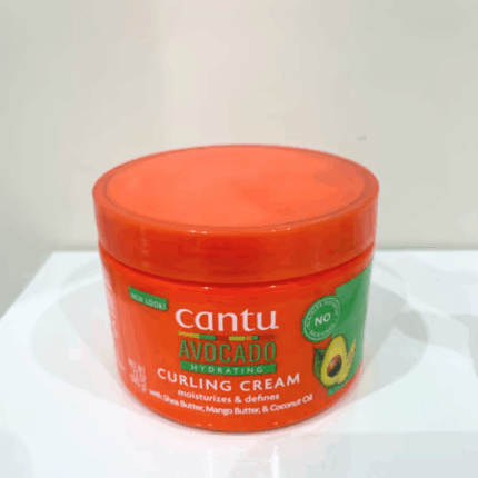 Real photo of cantu avocado hydrating curling cream jar placed on white surface