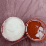 Open cantu avocado hydrating curling cream showing white cream texture inside jar