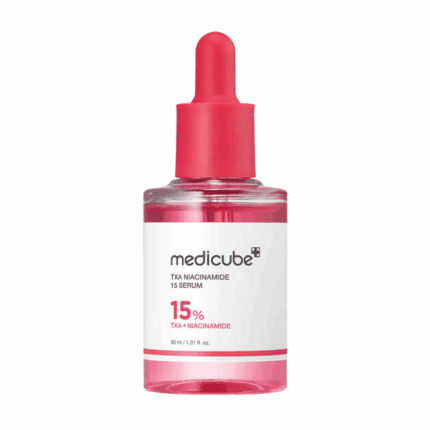 Front view of Medicube TXA Niacinamide 15 Serum 30ml pink glass dropper bottle with 15% TXA + Niacinamide label visible