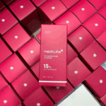 Multiple red Medicube TXA Niacinamide 15 Serum boxes stacked together highlighting 15% TXA + Niacinamide