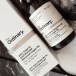 The Ordinary 100% Organic Cold-Pressed Moroccan Argan Oil bottle placed beside its original box