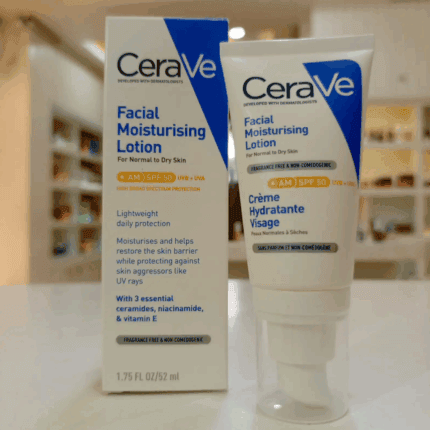A CeraVe Facial Moisturising Lotion AM SPF 50 shown with its packaging box and pump tube, placed on a countertop with a softly blurred indoor background, highlighting features for normal to dry skin and broad-spectrum UV protection.