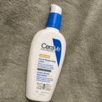 CeraVe AM Facial Moisturizing Lotion SPF 30 bottle with pump on a textured towel background.