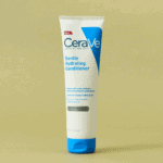 A tube of CeraVe Gentle Hydrating Conditioner with a white and blue design standing upright against a beige background, formulated with ceramides and hyaluronic acid to gently condition hair and support the scalp barrier.