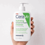 Hand holding CeraVe Hydrating Cream to Foam Cleanser 355ml for normal to dry skin, gentle face wash with ceramides and hyaluronic acid that removes makeup and hydrates skin.